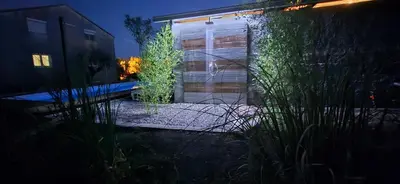 a glass door to a building at night at Owl's Nest in Bar