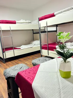 a room with a table and two bunk beds at Sneza in Podgorica