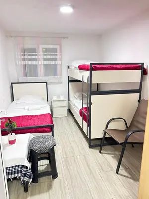 a room with two bunk beds and a chair at Sneza in Podgorica