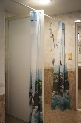 a shower curtain with a picture of the ocean at Sneza in Podgorica