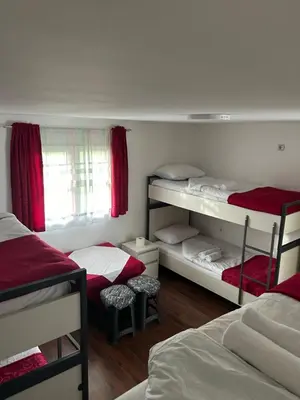 a bedroom with two bunk beds and a window at Sneza in Podgorica