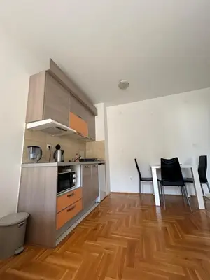 a kitchen and dining room with a table and chairs at Apartment Pegaz in Budva