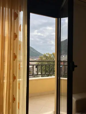 a room with a window with a view of a balcony at Apartment Pegaz in Budva