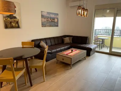 a living room with a couch and a table at Lux apartment Amarin in Pržno