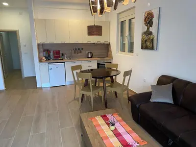 a living room with a couch and a table at Lux apartment Amarin in Pržno