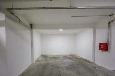 an empty garage with a red box on the wall at Lux apartment Amarin in Pržno