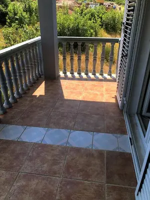 a porch with a railing and a tile floor at Captivating and Spacious 2-Bed House in Vranovici in Drakulovići