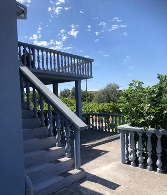 a stairway with a bench next to a fence at Captivating and Spacious 2-Bed House in Vranovici in Drakulovići