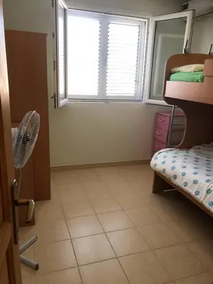 a room with a window and a room with bunk beds at Captivating and Spacious 2-Bed House in Vranovici in Drakulovići
