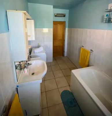 a bathroom with a sink and a toilet and a tub at Captivating and Spacious 2-Bed House in Vranovici in Drakulovići