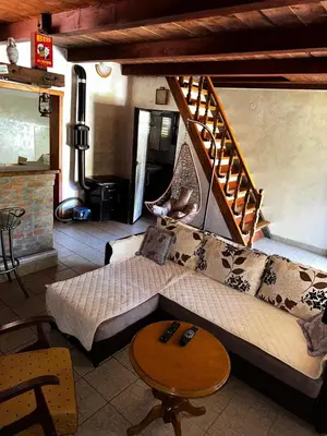 a living room with a couch and a staircase at Holiday Home Nikolić in Njeguši