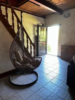 a hammock sitting in a room with a staircase at Holiday Home Nikolić in Njeguši