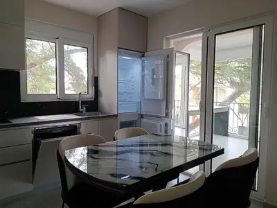 a kitchen with a glass table and chairs at Digital Nomads Apartments in Bar