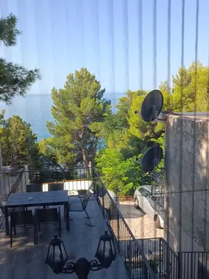 a balcony with a table and a view of the ocean at Digital Nomads Apartments in Bar