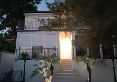 a white house with a white door and stairs at Digital Nomads Apartments in Bar