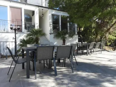 a table and chairs in front of a building at Digital Nomads Apartments in Bar
