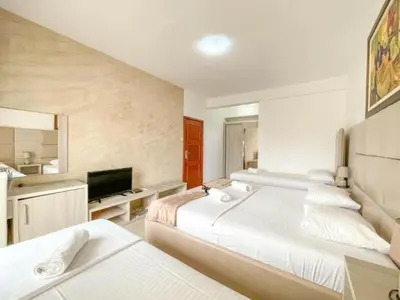 a large bedroom with two beds and a television at Imperial Hotel in Ulcinj