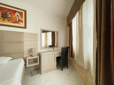 a bedroom with a desk and a bed and a mirror at Imperial Hotel in Ulcinj