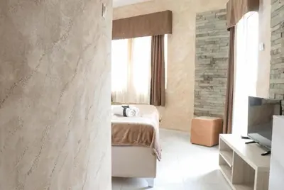 a bedroom with a bed and a television in a room at Imperial Hotel in Ulcinj