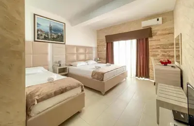 a hotel room with two beds and a window at Imperial Hotel in Ulcinj
