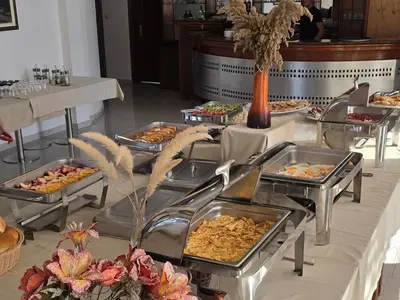 a buffet of food on a table in a restaurant at Imperial Hotel in Ulcinj
