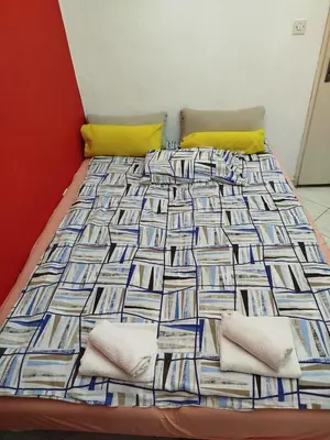 a bed with a colorful comforter in a room at Sandra Apartment 3 in Kotor