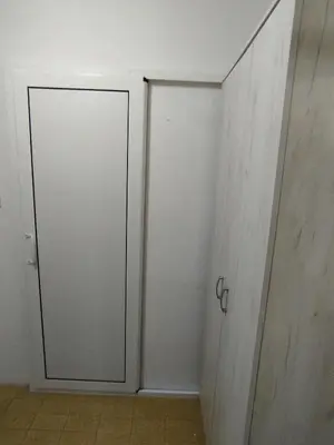 a white closet with a door in a room at Sandra Apartment 3 in Kotor