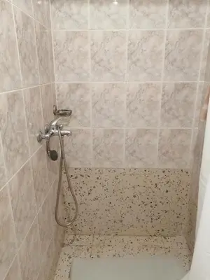 a shower with a hose in a bathroom at Sandra Apartment 3 in Kotor