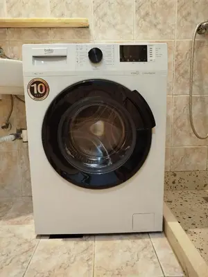 a white washing machine sitting in a kitchen at Sandra Apartment 3 in Kotor