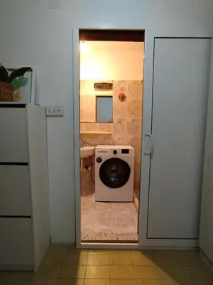 a door to a kitchen with a washing machine at Sandra Apartment 3 in Kotor