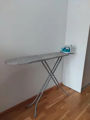 a ironing board on a table in a room at Nice apartment near Old Town and sea in Budva
