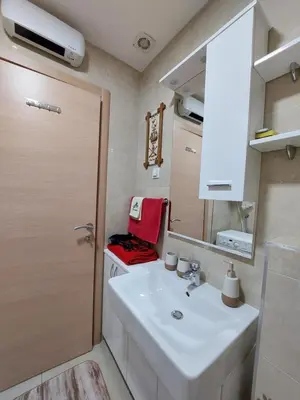 a bathroom with a white sink and a mirror at Nice apartment near Old Town and sea in Budva