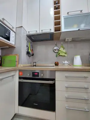 a kitchen with white cabinets and a black oven at Nice apartment near Old Town and sea in Budva