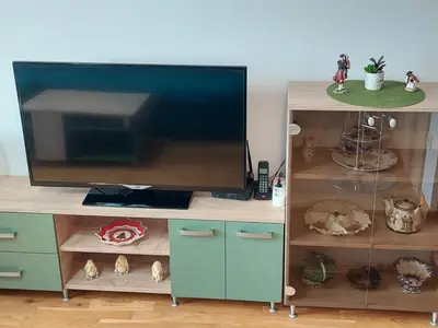 a flat screen tv sitting on top of a entertainment center at Nice apartment near Old Town and sea in Budva
