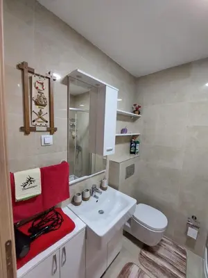 a bathroom with a white sink and red towels at Nice apartment near Old Town and sea in Budva