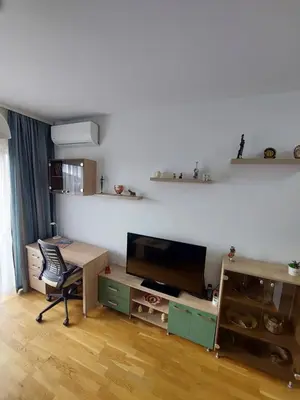 a living room with a desk and a tv and a table at Nice apartment near Old Town and sea in Budva