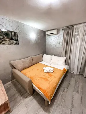 a small bedroom with a bed and a couch at AvR Street Budva in Budva