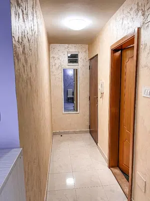 an empty hallway with a door and a window at AvR Street Budva in Budva