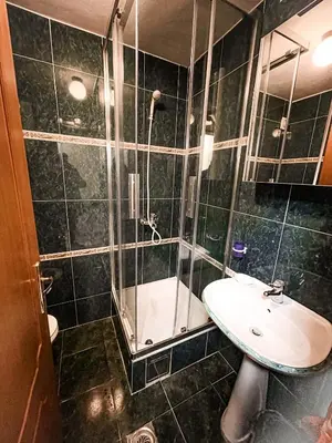 a bathroom with a sink and a glass shower at AvR Street Budva in Budva
