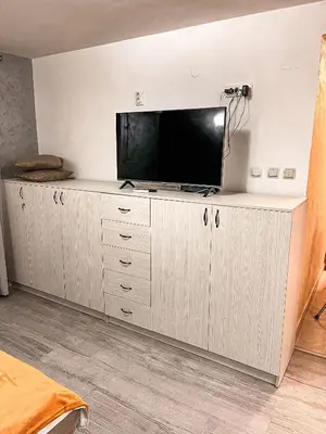 a living room with a flat screen tv on a cabinet at AvR Street Budva in Budva