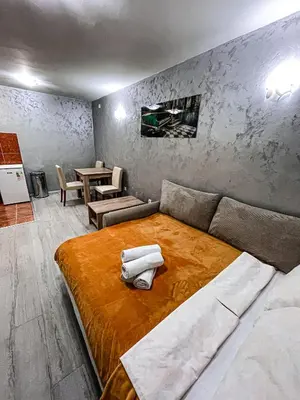 a bedroom with a large bed and a table at AvR Street Budva in Budva