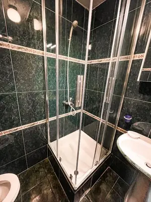 a bathroom with a shower with a toilet and a sink at AvR Street Budva in Budva