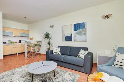 a living room with a couch and a table at 1-Bedroom Flat on the Main Square in the Old Town in Kotor