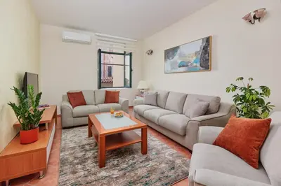 a living room with two couches and a table at Well Located 1Bedroom in the Heart of the Old Town in Kotor