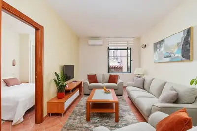 a living room with a couch and a table at Well Located 1Bedroom in the Heart of the Old Town in Kotor