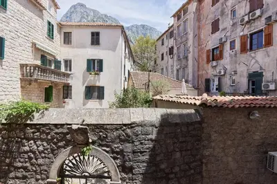 a stone wall in a city with buildings at Well Located 1Bedroom in the Heart of the Old Town in Kotor