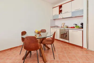 a kitchen with a table and chairs in a room at Well Located 1Bedroom in the Heart of the Old Town in Kotor
