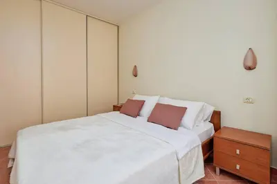 a bedroom with a large white bed with two pillows at Well Located 1Bedroom in the Heart of the Old Town in Kotor