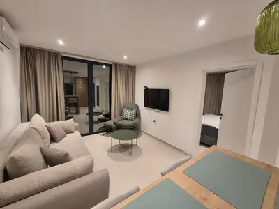 a living room with a couch and a chair at Guest House Damjana in Budva