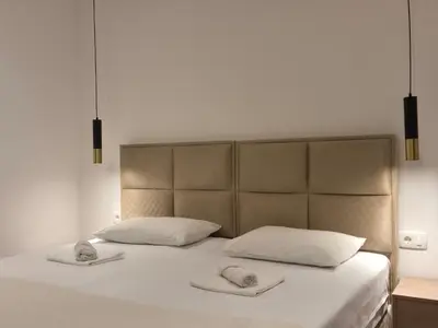 a bed with two phones on top of it at Guest House Damjana in Budva